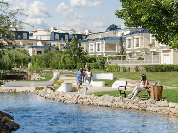 Rendering of a landscaped creek with gardens and residential buildings in the background at CreekView, New Cairo