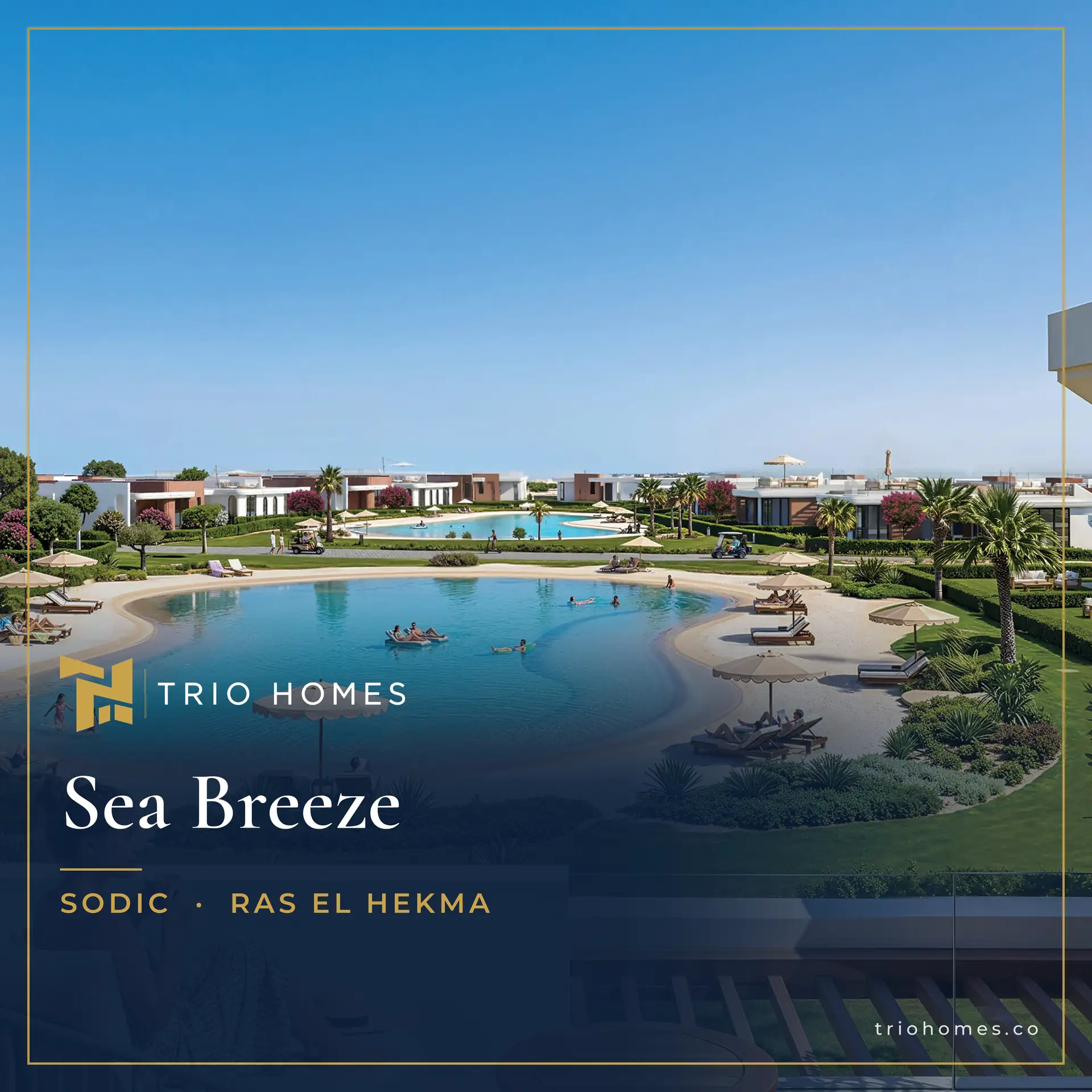 Terrace view over a swimming lagoon and landscaped gardens with low white villas at Sea Breeze by SODIC