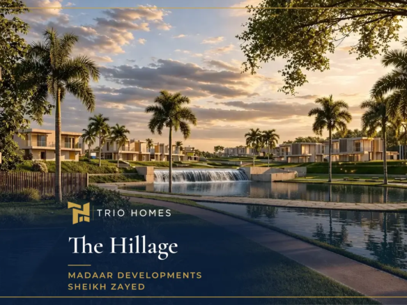 Lagoon and waterfall at sunset with homes behind at The Hillage Sheikh Zayed
